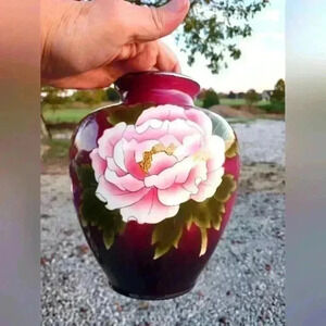 Antique flower vase. Maroon with pink & green. Has a chip but beautiful still.